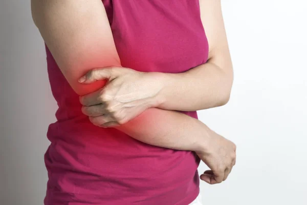 A woman has an elbow pain.