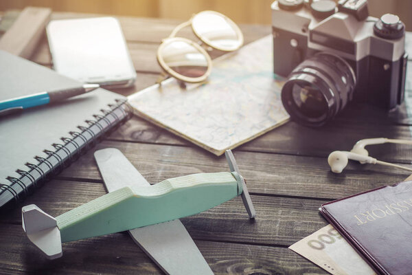 Top view accessories for vacation, flight. Airplane, passport, camera, money, phone, notebook - the concept of travel.