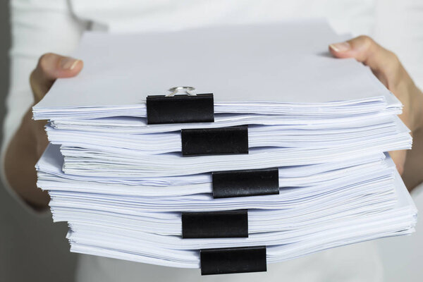 Stacks documents files with black clip.