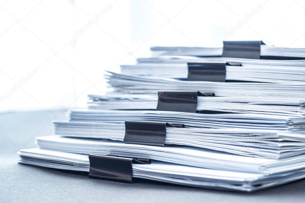 Stacks documents files with black clip.
