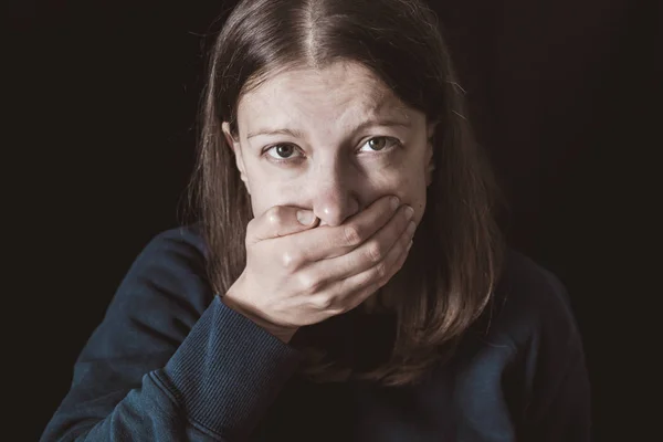 Woman with hands closed mouth. Female violence concept. Restriction and inability to speak.