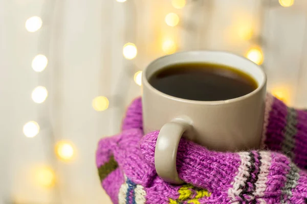 woman holding cup of hot drink in winter