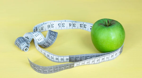 fresh apple with measuring tape. fresh tomato. sour milk product isolated on white background