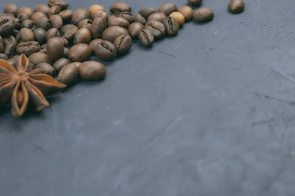 coffee beans loose in the corner of the background. on a dark background. view from above. copy space.