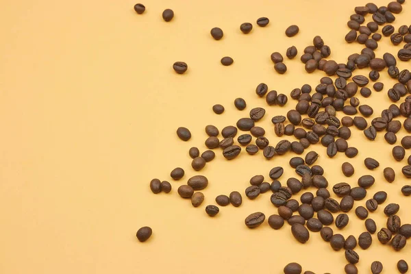 coffee beans loose in the corner of the background. on a dark background. view from above. copy space.