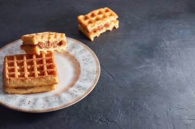 Üstten görünüm tatlı taze Viyana waffle ahşap masaya izole plaka üzerinde. kopya alanı. kahvaltıda hamur işleri.