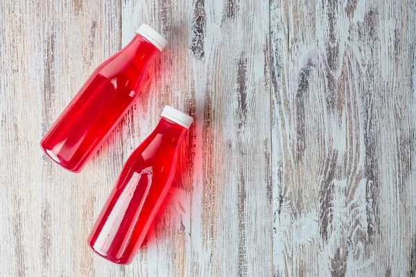 Plastik soda şişesi berry suyu iç ahşap zemin üzerinde. birkaç galon berry içki serinletici. Üstten Görünüm. kopya alanı.