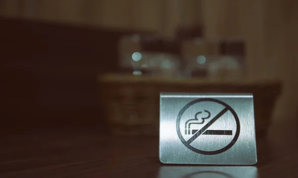 警告标志。在房间的桌子上禁止吸烟。桌子上的铁板不吸烟特写镜头。水平视图. — 图库照片