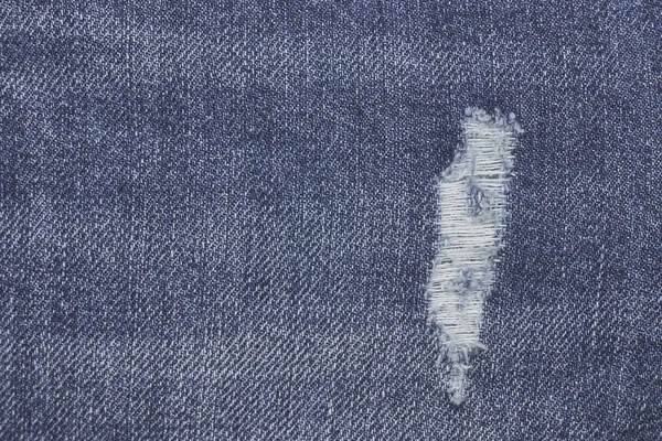 デニムはブルージーンズの質感をリッピング。抽象的な背景はジーンズをフェード。デザインの背景. — ストック写真