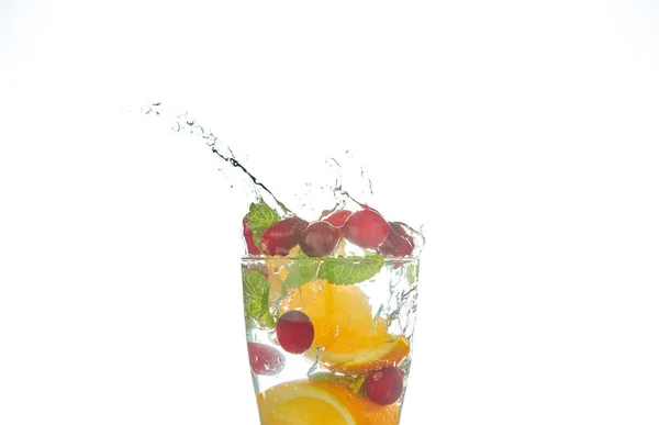 Coquetéis refrescantes de verão com citrinos e hortelã. segmentos de laranja e toranja. beba em uma mesa preta com cubos de gelo. close-up . — Fotografia de Stock
