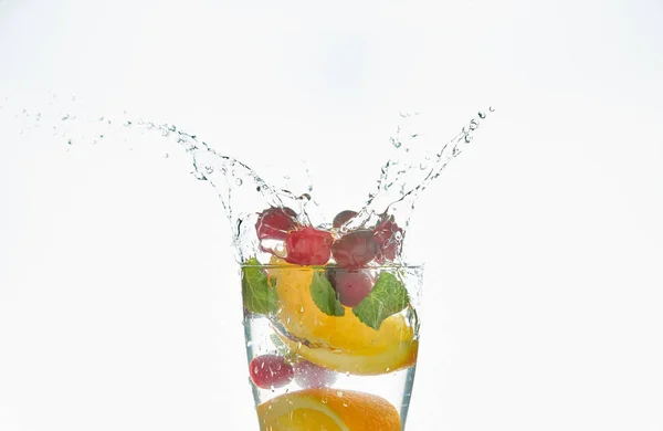Καλοκαιρινά δροσιστικά κοκτέιλ με εσπεριδοειδή και μέντα. φέτες πορτοκαλιού και μούρα. ποτό σε λευκό φόντο. Γκρο πλαν. — Φωτογραφία Αρχείου
