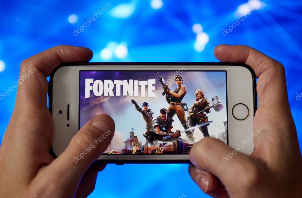San Francisco, CA USA - April 2019: hand holding a phone with a Fortnite game logo