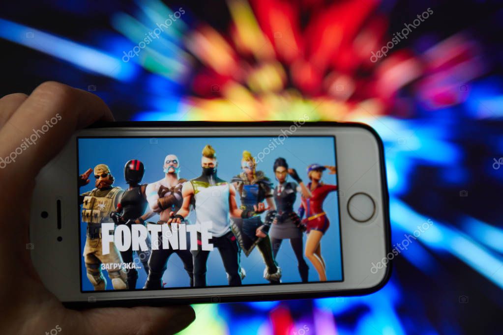 San Francisco, CA USA - April 2019: hand holding a phone with a Fortnite game logo
