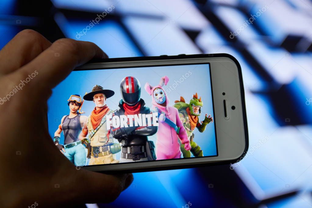 San Francisco, CA USA - April 2019: hand holding a phone with a Fortnite game logo