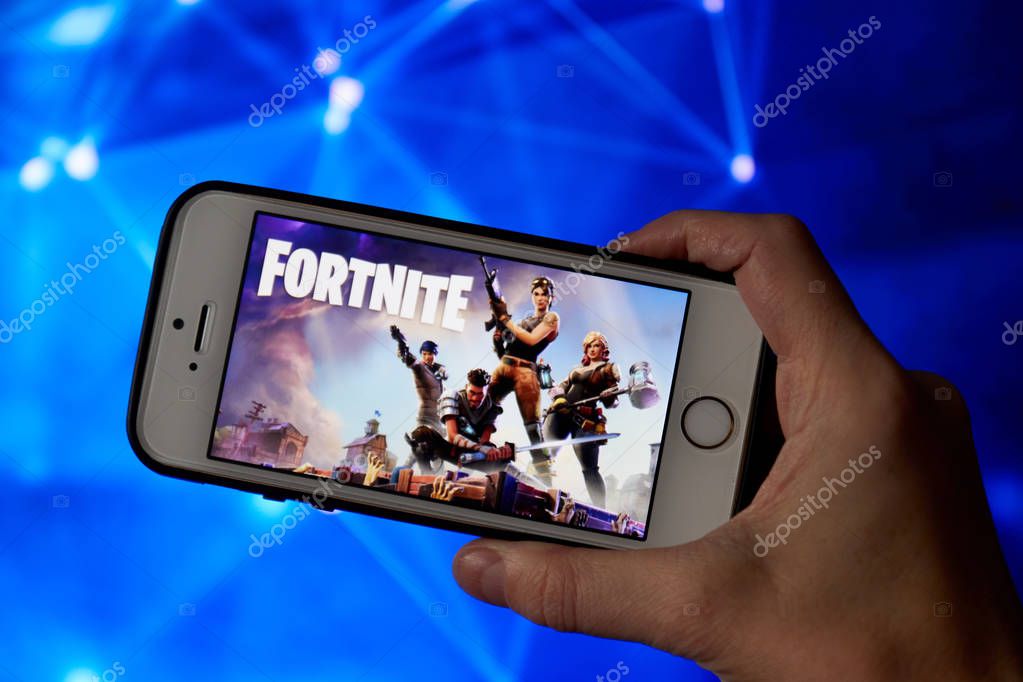San Francisco, CA USA - April 2019: hand holding a phone with a Fortnite game logo