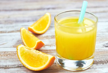 Bir bardak taze portakal suyu ve eski bir masa ışığı üzerinde portakal dilimleri. yatay görünüm. Detoks. Close. Kopya alanı narenciye ferahlatıcı içecek.