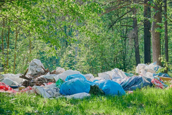 pollution of nature. Ecology protection concept. Dirty green messy nature landscape with a pile of waste garbage.