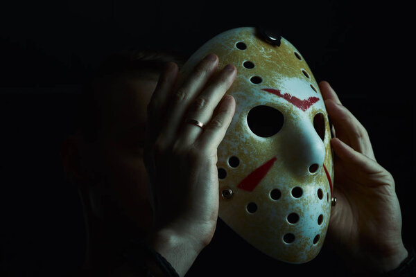 Miami, Florida USA - May 3, 2019. Friday 13th hockey mask of Jason Voorhees. Halloween concept. day of death. man in a jason mask on a black background.