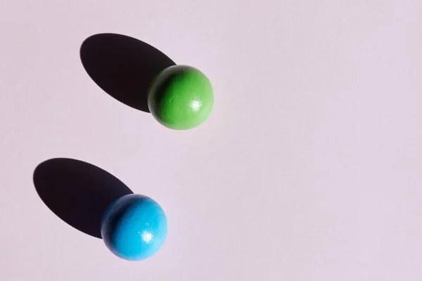 Un par de bolas de colores sobre un fondo claro con sombras duras. fondo abstracto para el diseño. Copiar espacio. geometría — Foto de Stock