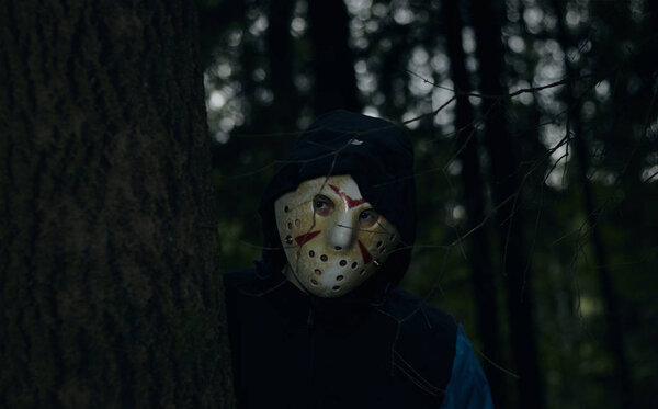 Miami, Florida USA - May 3, 2019. Friday 13th hockey mask of Jason Voorhees. Halloween concept. day of death. man in a jason mask on a black background.