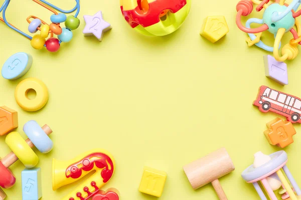 Top view on children s toys on a yellow background. Childrens toys on the table. concept for advertising toys for children. Copy space childrens toy. — Stock Photo, Image