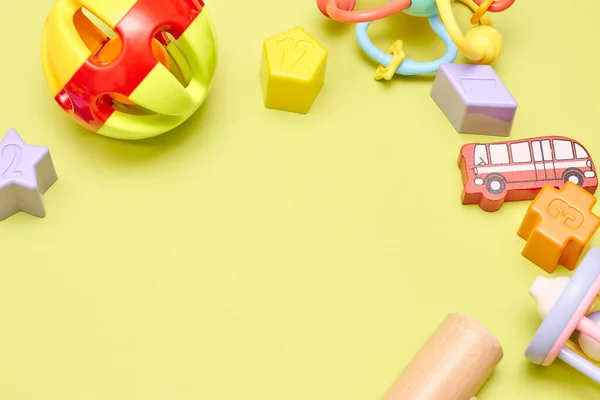 Top view on children s toys on a yellow background. Childrens toys on the table. concept for advertising toys for children. Copy space childrens toy. — Stock Photo, Image