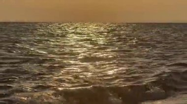 Denizde güzel bir gün batımı. Gün batımında deniz dalgaları. Yunanistan 'da Ege Denizi, Halkidiki. Meditasyon için rahatlatıcı video