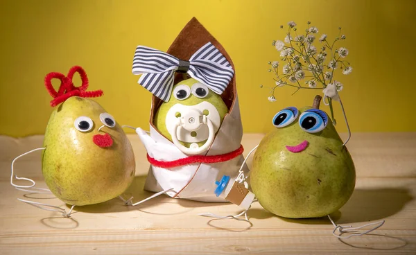 Three pears are on the table.One pear-mother, the second pear-child and the third pear - father.