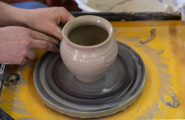 Potter 'ın tekerleği ile seramik pot yapımında Master sınıfı. Çömlek, ekseninin etrafında dönüyor. — Stok fotoğraf