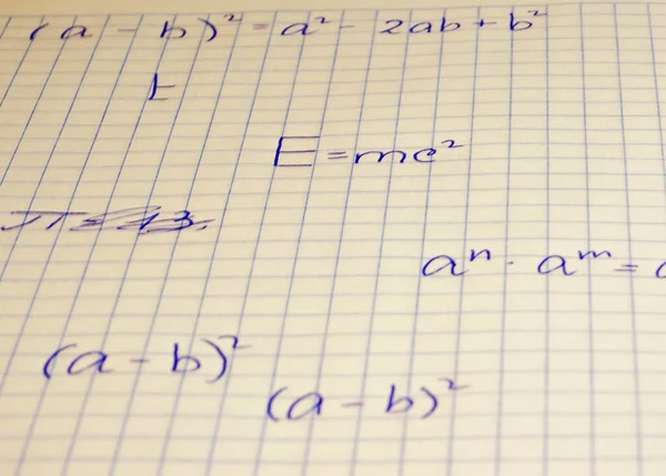 Written on a notebook checkered sheet of formulas. — Stock Photo, Image