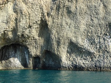 Sakin deniz suyundan yükselen görkemli kayalar.
