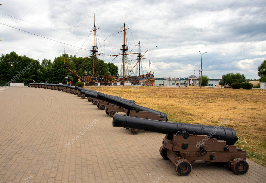 Russia, Embankment in Voronezh, August 2020. Vintage cannons as a decoration on the square in Voronezh. In the background is a huge wooden ship