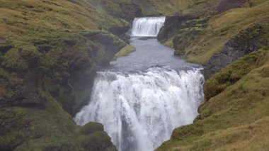 İzlanda. İzlanda 'da Şelale Skogafoss. Ünlü turistik mekan ve çevre yolunda doğal dönüm noktası..