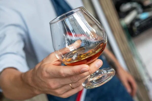 Een glas Cognac in een Waiter's Hand — Stockfoto