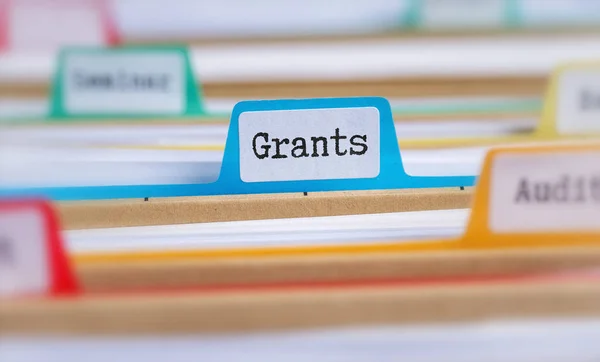 File folders with a tab labeled Grants — Stock Photo, Image