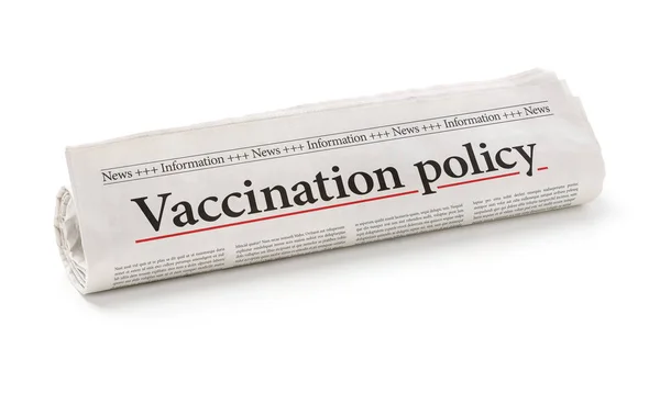 Gazeta walcowana z nagłówkiem polityka szczepień — Zdjęcie stockowe