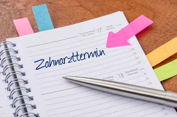 Daily planner with the entry Dentist appointment - Zahnarzttermi — Stock Photo, Image