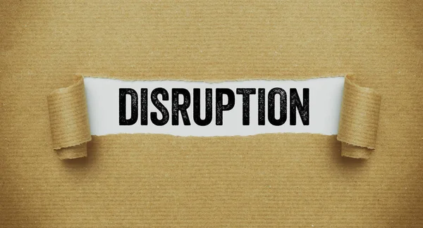 Torn brown paper revealing the word Disruption — Stock Photo, Image