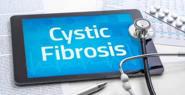 Het woord cystische fibrose op het scherm van een tablet — Stockfoto
