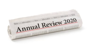 Rolled newspaper with the headline Annual review 2020 clipart