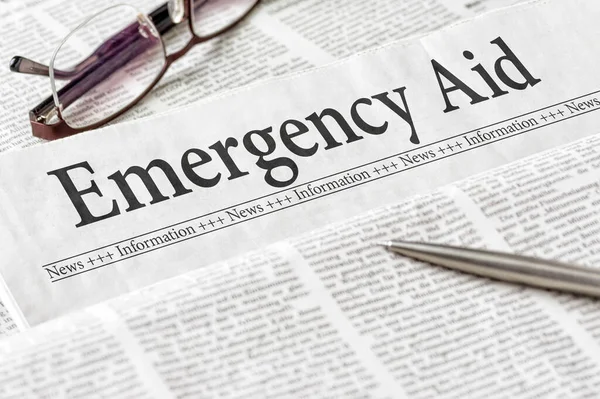 Newspaper Headline Emergency Aid — Stock Photo, Image