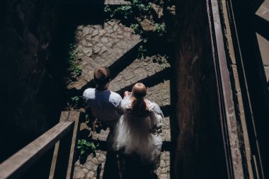 top view of bride and groom walking by old town clipart