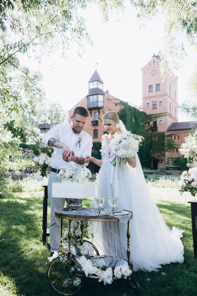 bride and groom cutting wedding cake during ceremony