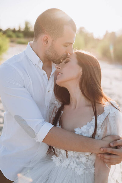 stylish tender couple embracing on beach