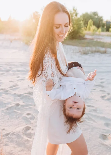 Junge Mutter hat Spaß mit Baby am Strand — Stockfoto