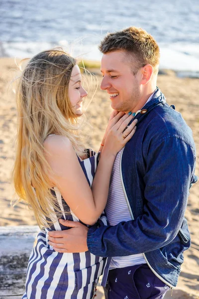 Happy romantic couple in love on sandy beach with sea on background — Stock Photo