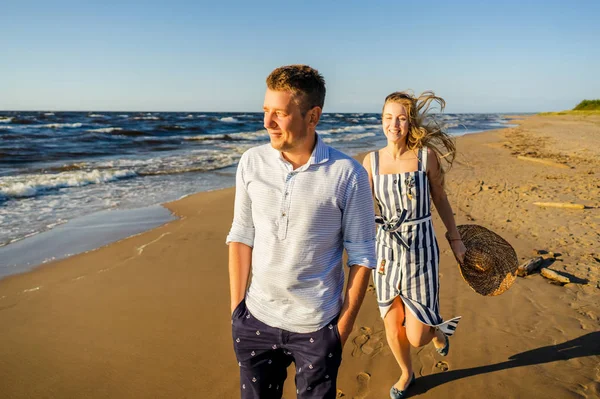 Portrait of happy couple in love walking on sandy beach in Riga, Latvia — Stock Photo