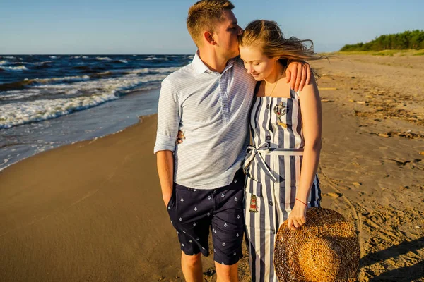 Joven pareja tierna enamorada en la playa de arena en Riga, Letonia - foto de stock