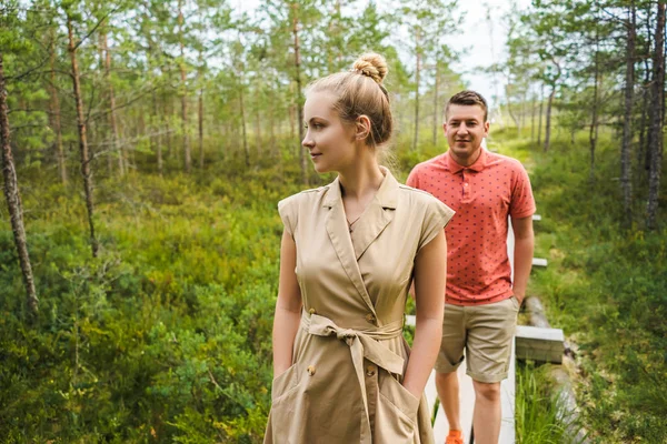 Portrait of couple in love on wooden bridge with green plants on background — Stock Photo