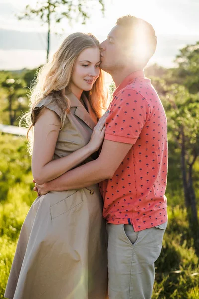 Portrait of loving couple hugging with green plants on background — Stock Photo